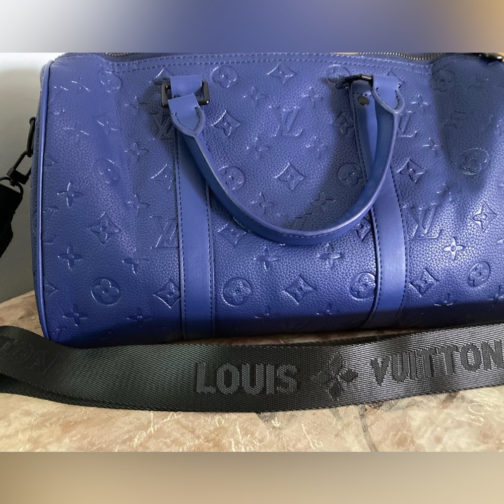 Blue L V monogram embossed duffel bag